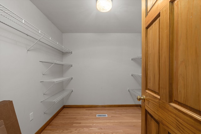spacious closet with visible vents and light wood-style flooring