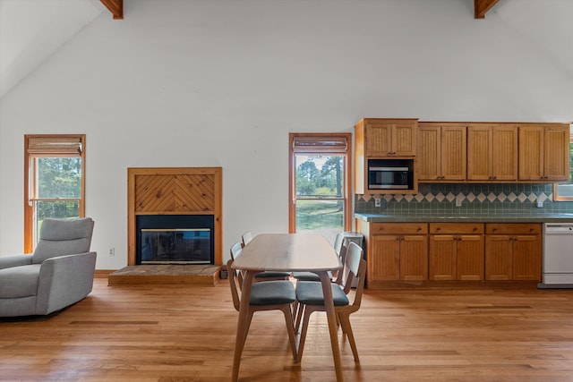 kitchen featuring beamed ceiling, white dishwasher, high vaulted ceiling, and stainless steel microwave