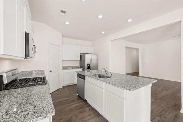 kitchen with white cabinets, appliances with stainless steel finishes, dark wood-type flooring, and a sink