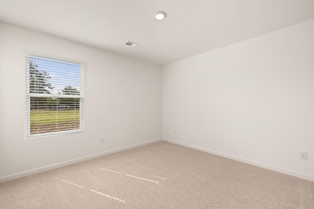 carpeted empty room with baseboards