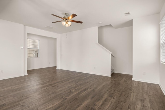 unfurnished living room featuring visible vents, dark wood-type flooring, a ceiling fan, and stairway