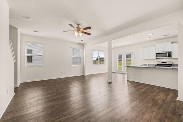 unfurnished living room featuring a ceiling fan, visible vents, baseboards, recessed lighting, and dark wood-type flooring