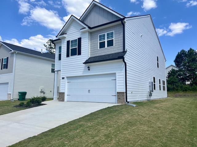 view of front of house with driveway, an attached garage, a front yard, and board and batten siding