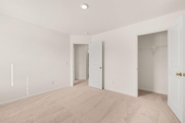 unfurnished bedroom with a closet, baseboards, and carpet floors