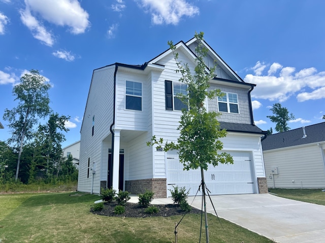 view of front of home with board and batten siding, a front lawn, a garage, and driveway