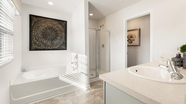 full bathroom with recessed lighting, vanity, a bath, and a shower stall