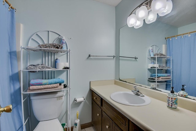 bathroom featuring vanity, toilet, and walk in shower