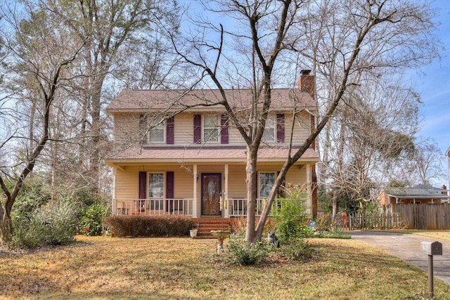 view of front of property featuring covered porch and a front yard