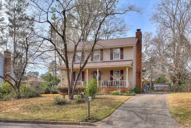 view of front of home with covered porch and a front yard