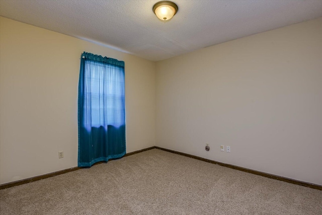 carpeted spare room featuring a textured ceiling