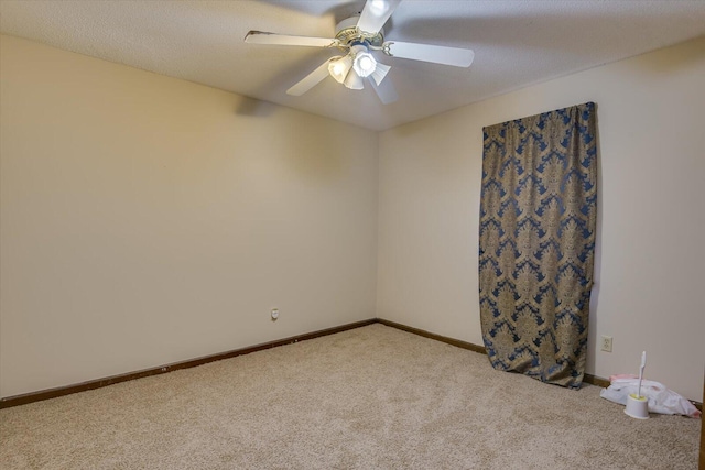 carpeted spare room featuring a textured ceiling and ceiling fan