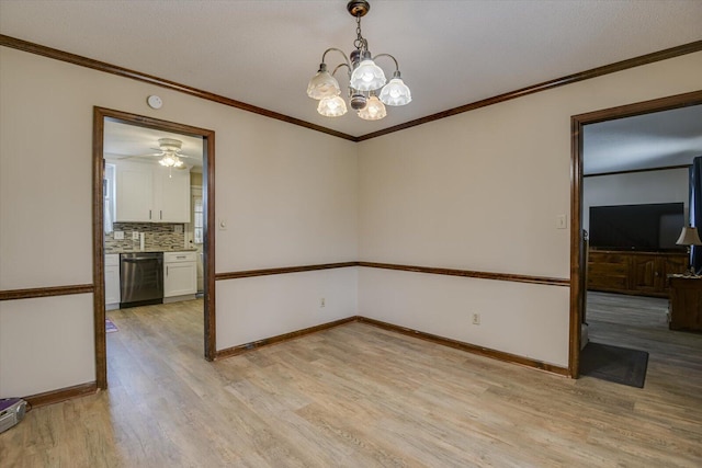 empty room featuring ornamental molding, an inviting chandelier, and light hardwood / wood-style flooring