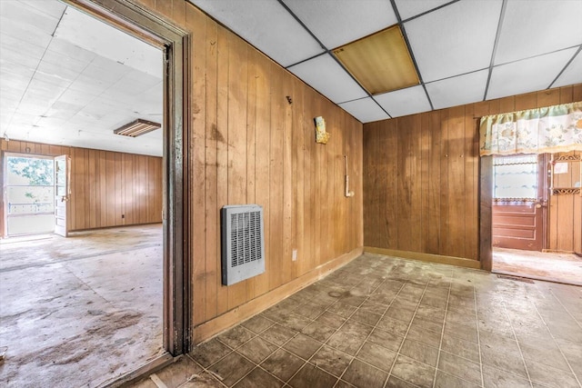 485 Adams St, Sparta, GA 31087 - spare room featuring wooden walls, heating unit, and a drop ceiling