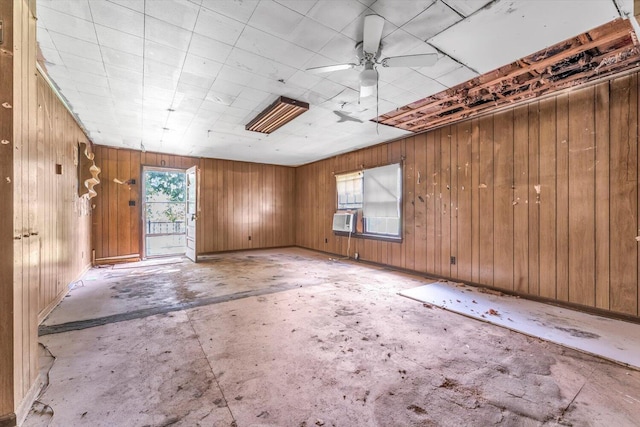 485 Adams St, Sparta, GA 31087 - spare room featuring cooling unit, concrete floors, wood walls, and a ceiling fan