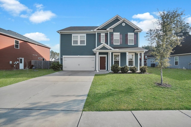 traditional-style home featuring an attached garage, driveway, a front lawn, and fence