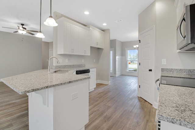 1675 Pine Ridge Dr N, Hephzibah, GA 30815 - kitchen with a sink, a peninsula, stainless steel microwave, light wood-style floors, and ceiling fan