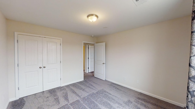 unfurnished bedroom with a closet and carpet