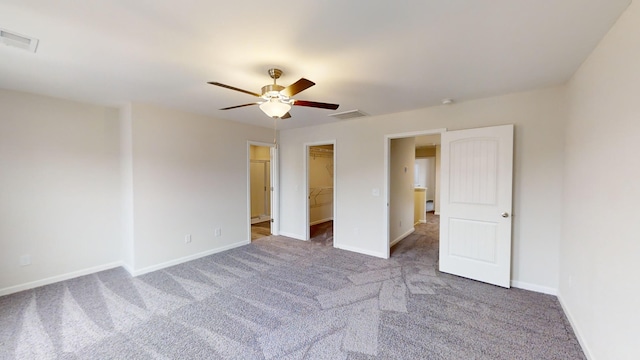 carpeted empty room featuring ceiling fan