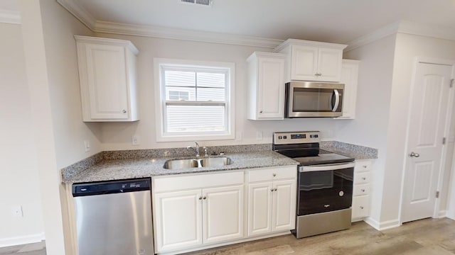 kitchen featuring appliances with stainless steel finishes, light stone countertops, white cabinets, light hardwood / wood-style flooring, and sink