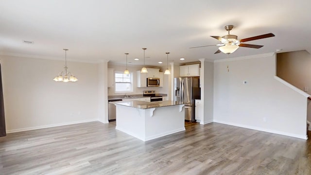 kitchen with a kitchen island, appliances with stainless steel finishes, decorative light fixtures, and a kitchen breakfast bar