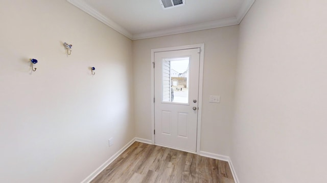 entryway featuring ornamental molding and light hardwood / wood-style flooring