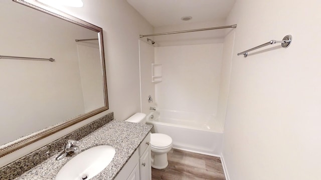 full bathroom with hardwood / wood-style floors,  shower combination, vanity, and toilet