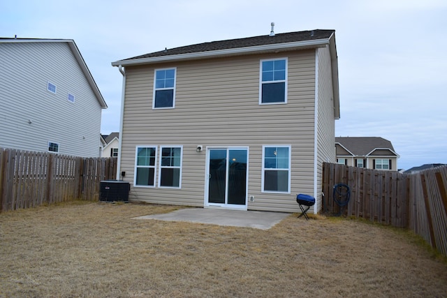 rear view of house with a patio area, central AC unit, and a yard