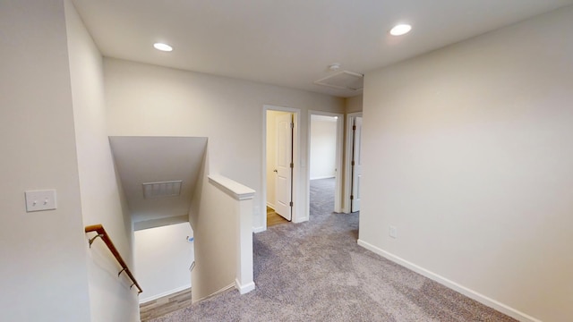 hallway with light colored carpet