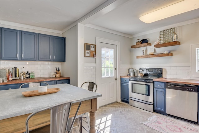 1703 Marion Ave, North Augusta, SC 29841 - kitchen with stainless steel appliances, butcher block counters, blue cabinets, brick patterned flooring, and backsplash