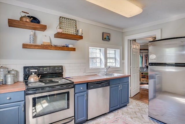 1703 Marion Ave, North Augusta, SC 29841 - kitchen with appliances with stainless steel finishes, blue cabinetry, butcher block countertops, open shelves, and tasteful backsplash