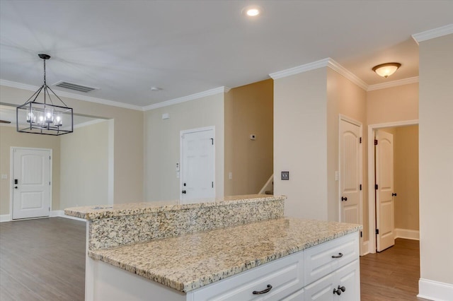 kitchen featuring crown molding, white cabinets, and wood finished floors