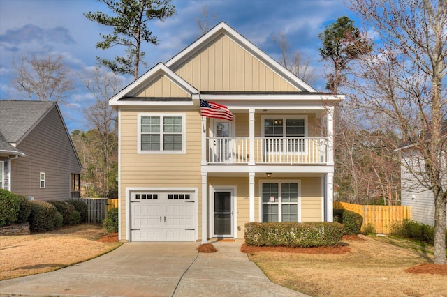 view of front of home with board and batten siding, fence, a balcony, a garage, and driveway