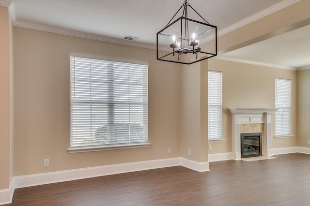 unfurnished living room featuring baseboards, ornamental molding, dark wood-style flooring, a fireplace, and a notable chandelier