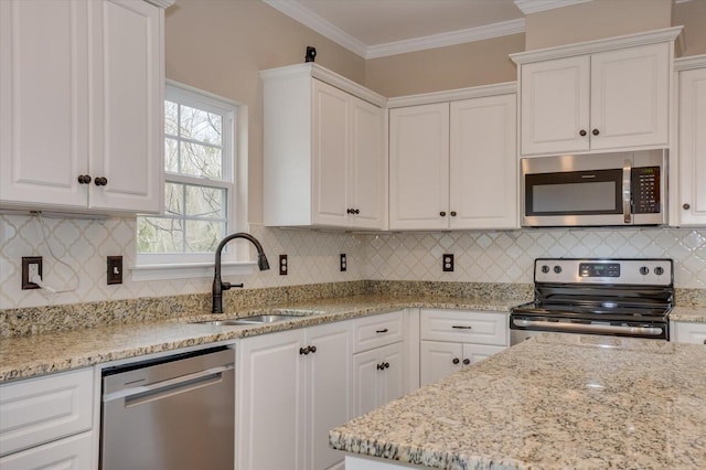 kitchen with stainless steel appliances, a sink, white cabinetry, and crown molding