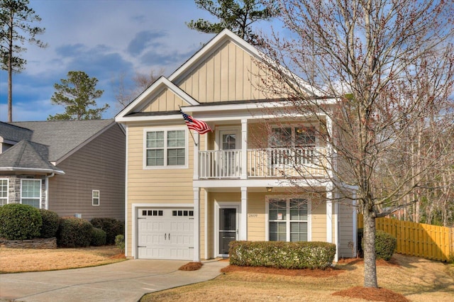 view of front of property with driveway, a balcony, an attached garage, fence, and board and batten siding