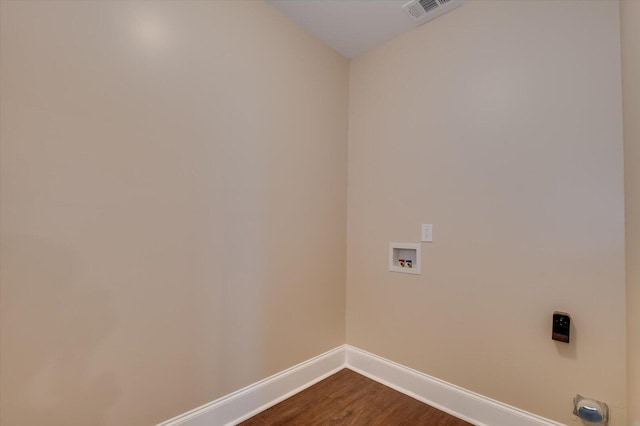 laundry room with hookup for a washing machine, visible vents, dark wood-type flooring, laundry area, and baseboards