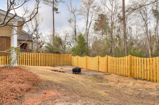 view of yard with an outdoor fire pit and a fenced backyard