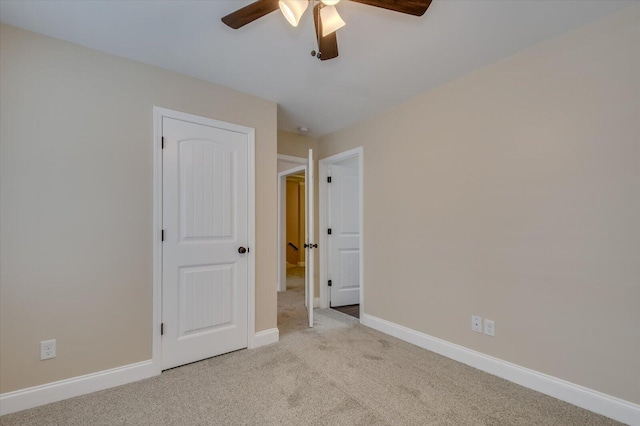 unfurnished bedroom with carpet, baseboards, and a ceiling fan