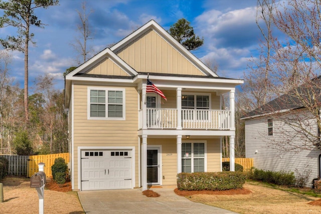 view of front of property with concrete driveway, board and batten siding, fence, a balcony, and a garage