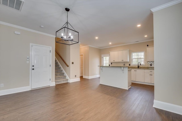 kitchen with tasteful backsplash, dark wood-style flooring, visible vents, and crown molding