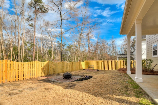 view of yard with an outdoor fire pit and a fenced backyard