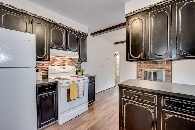 3554 Gardenbrook Dr, Augusta, GA 30906 - kitchen featuring white appliances, under cabinet range hood, dark countertops, light wood-style floors, and tasteful backsplash