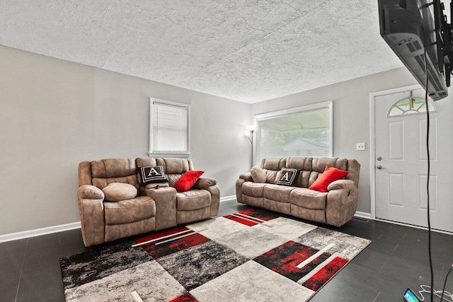 living room featuring a textured ceiling and a healthy amount of sunlight