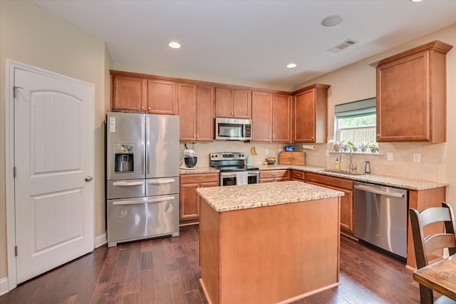 1548 Driftwood Ln, Grovetown, GA 30813 - kitchen featuring appliances with stainless steel finishes, dark wood-style floors, decorative backsplash, light stone counters, and recessed lighting