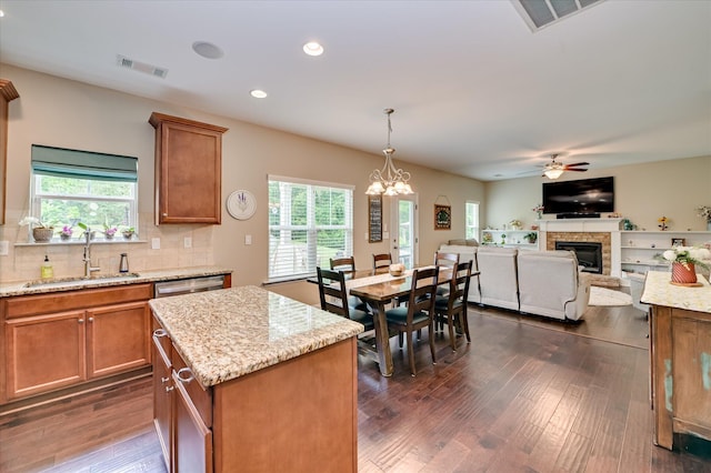 1548 Driftwood Ln, Grovetown, GA 30813 - kitchen with a glass covered fireplace, ceiling fan, plenty of natural light, brown cabinets, and recessed lighting