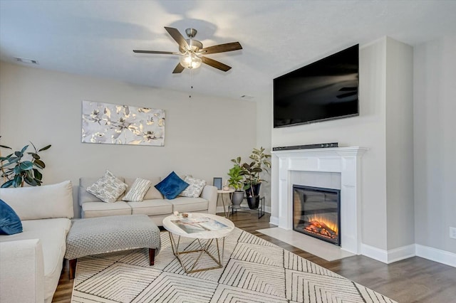 living room featuring ceiling fan and wood-type flooring