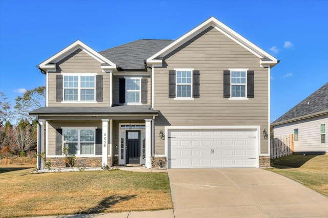 view of front of home featuring a front yard and a garage