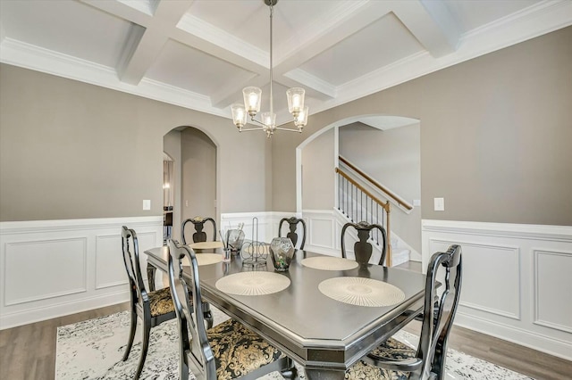 dining room with coffered ceiling, beam ceiling, dark wood-type flooring, and an inviting chandelier