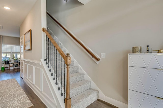 stairs with hardwood / wood-style floors