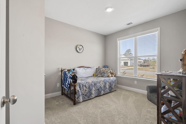 carpeted bedroom with baseboards and visible vents